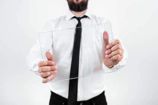 Male Corporate Holding Transparent Glass And Presenting Important Sales Data. Businessman Wearing Necktie Displaying New Ideas And Strategies For The Marketing.