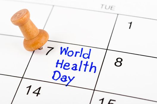 The Handwriting Reminder World Health Day in calendar with wooden pin. April 07.