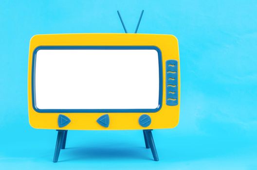 The Vintage Miniature Toy Television on blue background with clipping path.