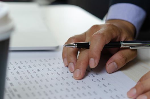 Businessman hands use pen to document business percentage figures. Finance and accounting analysis of economic and investment business concept.