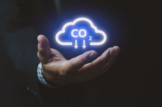 Man hand icon cloud. Sustainable eco energy CO2 emissions and global warming with investment constraints  icons and symbols virtual screen. Business concept.