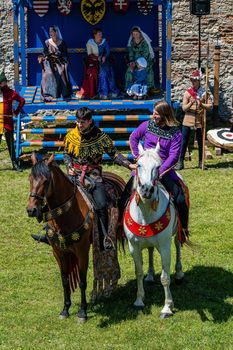Two knights in period costumes on horseback