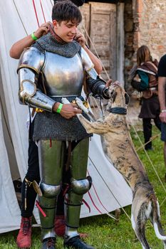 The knight greets his dog. Show of affection