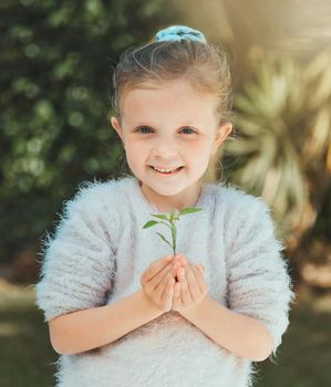 Love, honesty, and connection are cultivated in a family. a little girl holding a plant outside.