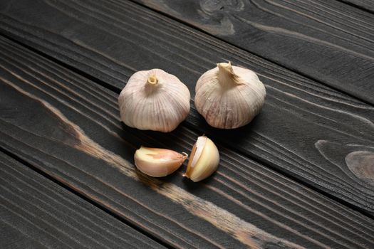 Fresh garlic on a rustic wooden background.