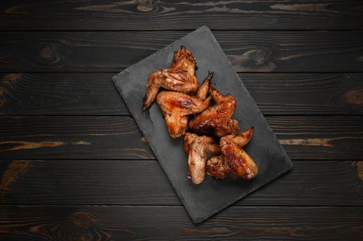 appetizing chicken wings grilled barbecue with spices and vegetables until crisp