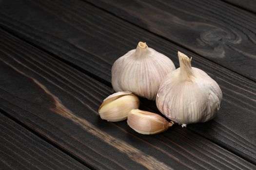 Fresh garlic on a rustic wooden background.