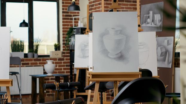 Empty art class with artistic equipment and canvas with easel