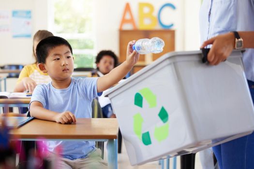 Always eager to answer. a leaner and teaching recycling in a classroom.