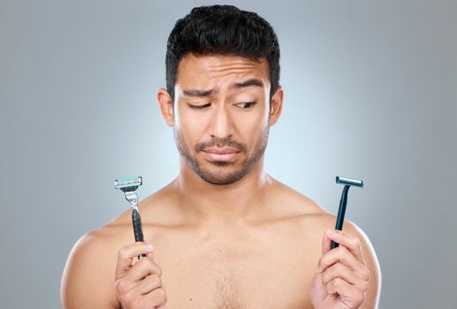 Can you tell me what the difference is. a man deciding between two razors.