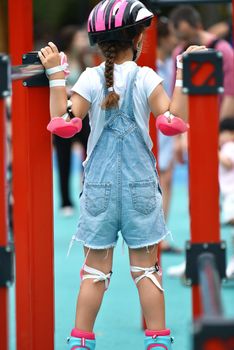 selective focus. Little girl child in protective clothing helmet knee pads
