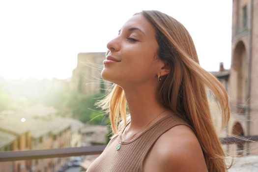 Profile of woman breathe relaxed with closed eyes on sunset. Beauty sunshine girl side portrait. Positive emotion life success mind peace concept.