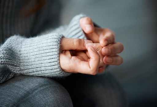 Nervous habits can develop. a woman nervously clasping her hands together.