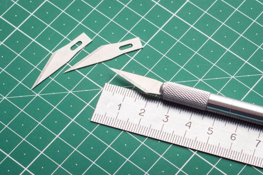 Scalpel, ruler and two sharp blades
