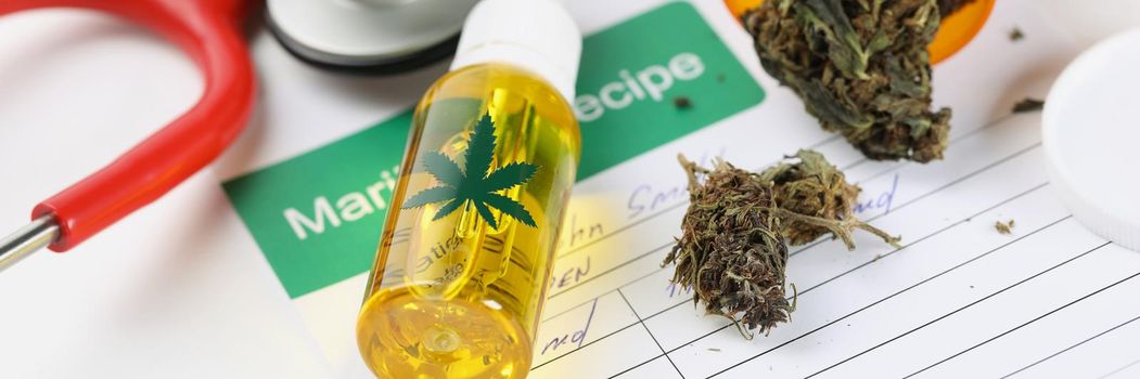 Jar with dried marijuana scattered on patient medical prescription