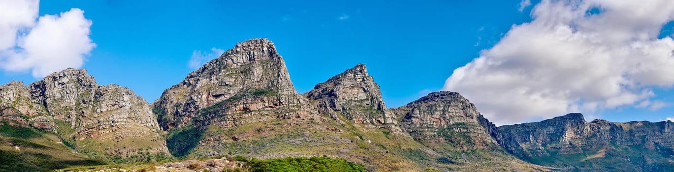 Mountain landscape against a cloudy blue sky background with copy space. Rocky hills and cliffs on The twelve apostles in Cape Town, Western Cape. Beautiful travel destination and tourist attraction