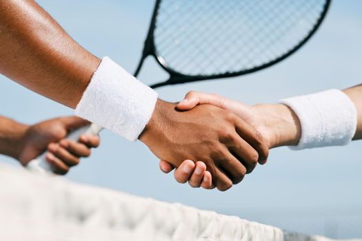 Pleasantly surprised. two unrecognizable tennis players shaking hands during a tennis match.