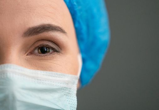 Woman's eye In Protective Mask Looking At Camera