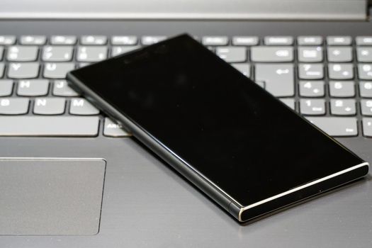 Smartphone on the laptop keyboard