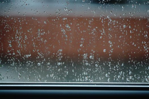 Raindrop on the glass bokeh effect texture template background