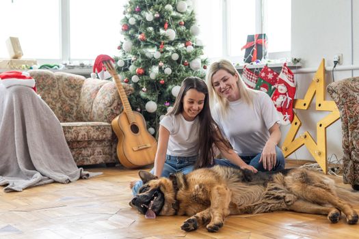 mother and daughter, dog at christmas
