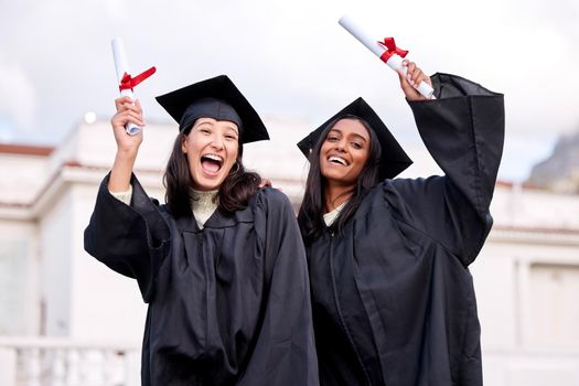 Were going to be celebrating all day long. Portrait of two young women celebrating with their diplomas on graduation day.