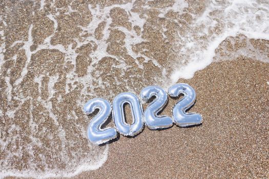 2022 figures in the water on the golden sea sand