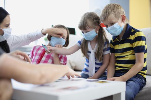 Woman keep checking on kids health, ask to wear face mask, prevent covid spread