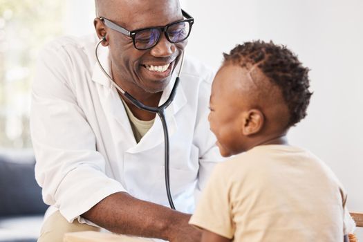The heart of a champion. a doctor examining an adorable little boy with a stethoscope.
