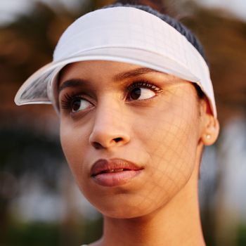 I want people to see just how great I am. Closeup shot of a tennis player wearing a white visor.