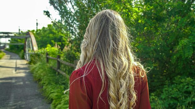 Back view of woman with beautiful long blond hair