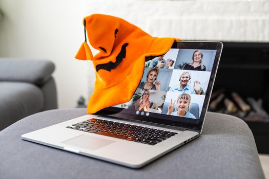 laptop with video conferencing and halloween decor.