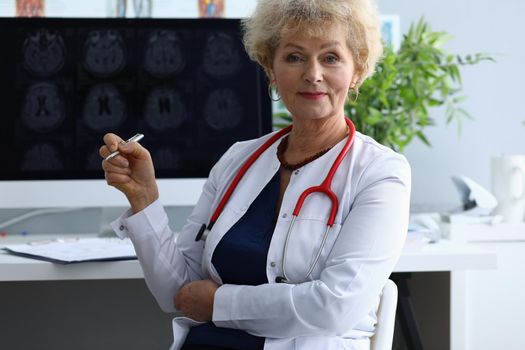 Portrait of elderly woman doctor in field of medicine