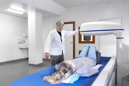 Doctor introducing a patient to the x-ray machine