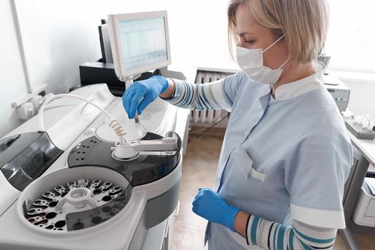 Doctor using a centrifuge in a hospital