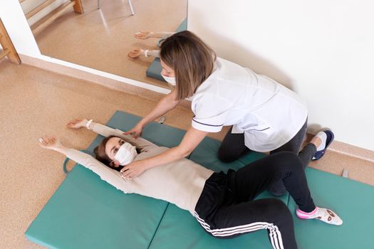 Top view of a doctor working in a rehab of a patient