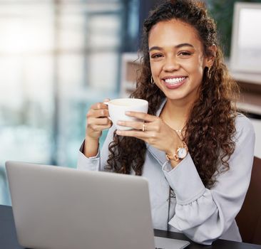 I feel ready to tackle the day. a young businesswoman enjoying a cup of coffee at work.