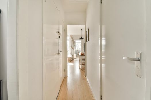 White corridor in modern apartment with parquet floor