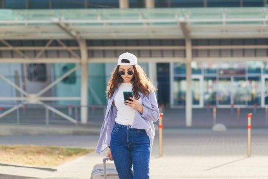 Young beautiful girl woman with suitcase and phone, calling someone, looking for calling