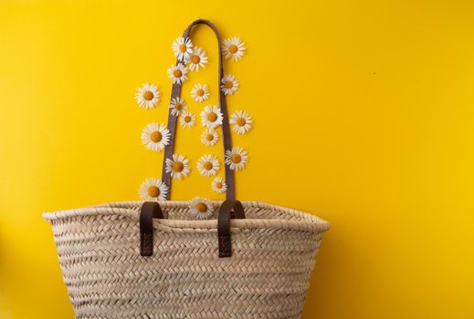 daisies fall into a straw bag