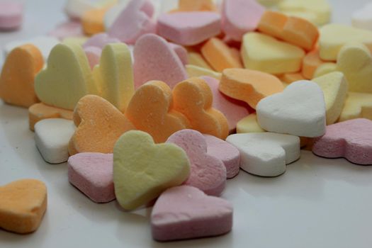 Pile of pastel colored candy hearts