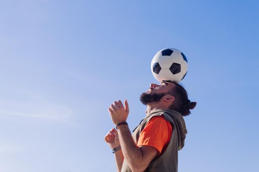 football player balancing the ball on his head