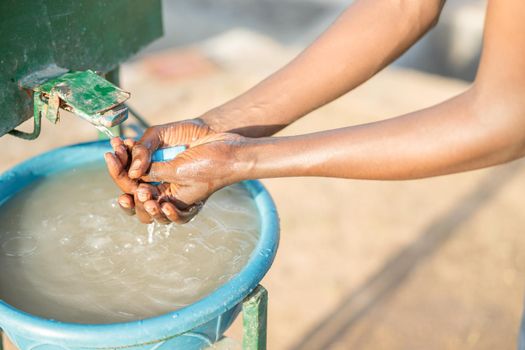 Close up of African American worker washing hands at coffee farm