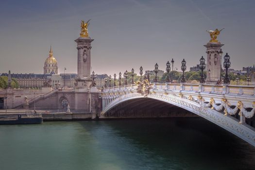 Pont Alexandre III and Invalides dome on Seine river, Paris, france
