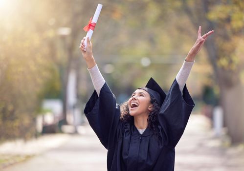 Let everything youve learned carry you far. a young woman cheering on graduation day.