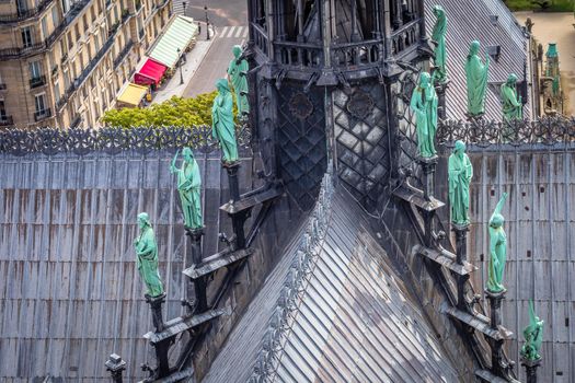Notre Dame Cathedral of Paris spire from above with statues, France