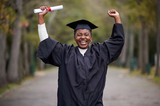 My journey to success continues from here on. Portrait of a young woman cheering on graduation day.