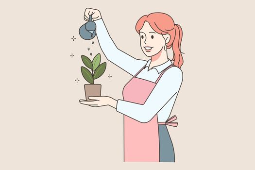 Happy woman watering plant