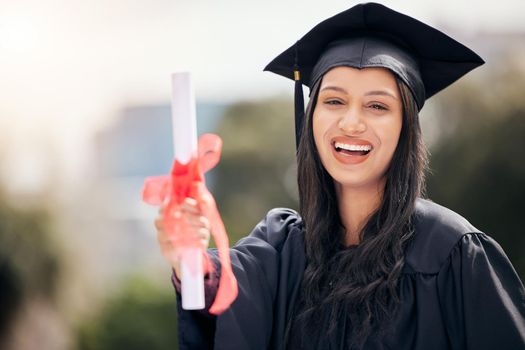Hard work gets you hard proof. Cropped portrait of an attractive young female student celebrating on graduation day.