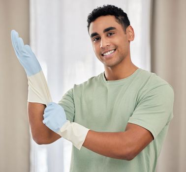 Gloves at the ready. a young man applying latex gloves.